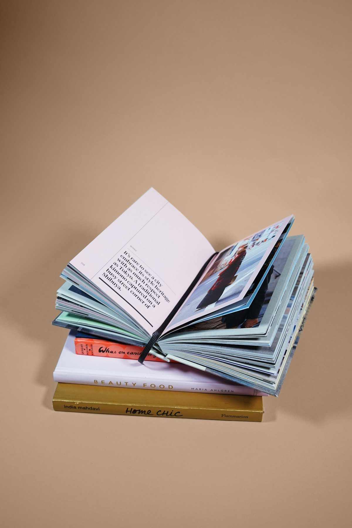 An open book resting on a stack of journals